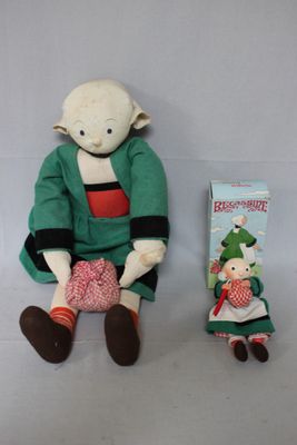 a small stuffed toy sitting next to a book