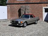 a silver car parked in front of a brick building