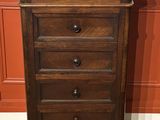 an image of a tall wooden chest of drawers with a marble top