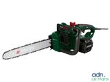 a green and black chainsaw sitting on top of a white surface