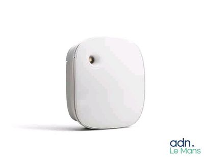 a close up of a small white device on a white surface