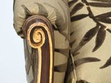 a close up of a chair with a floral pattern on it