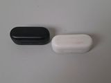 two black and white pill sitting on top of a white table