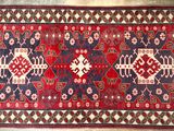 a red and blue rug with a pattern on it