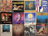 a wall full of various music cds on a wall