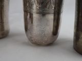 three silver cups sitting next to each other on a table