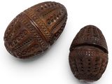 two carved wooden boxes with carvings on them on a white surface