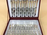 silverware in a wooden case with silverware in it