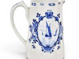 blue and white porcelain pitcher with a sailboat motif