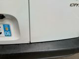 a close up of a white car with a number plate on it