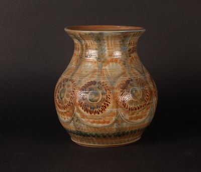 a vase that is sitting on a black surface
