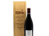 a bottle of wine sitting next to a wooden box