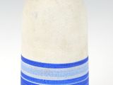 a white vase with a blue stripe on it