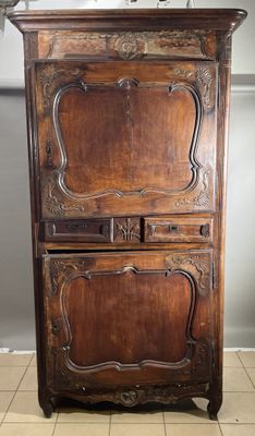 an old wooden cabinet with a mirror on top of it