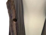 the back view of a woman ' s coat with a fur collar