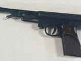 an old toy gun is on a white surface with a white background