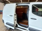 a white van with its doors open in a garage