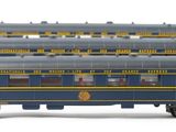 three blue and yellow train cars sitting next to each other on a white surface