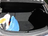 a trunk of a car with a blue bag in it
