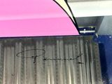 a close up of a pink umbrella with a black writing on it