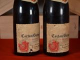 two bottles of wine sitting next to each other on a table