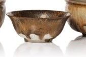 three bowls and a bowl sitting next to each other on a white surface