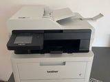 a printer sitting on top of a table with a charger