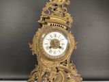 a gold clock that is sitting on a table