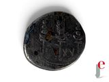 a close up of a coin on a white surface