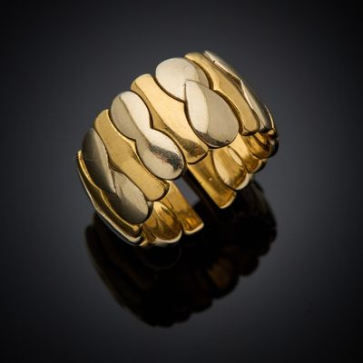 a close up of a gold ring on a black surface