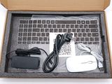 a box with a keyboard, mouse, and charger inside of it