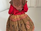 a figurine of a woman in a dress and hat