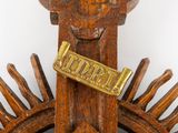 a close up of a wooden object with a sign on it