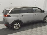 a picture of a grey car parked in a garage