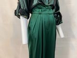 green satin dress with black satin jacket and matching skirt