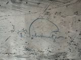 a close up of a graffiti on a concrete surface