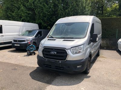 a white van parked in a parking lot next to a white van