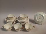 several cups and saucers sitting on top of a white table