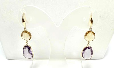 amethorate and citrine earrings on display on a white mannequin