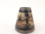 a black and white vase with a picture of a man on it