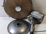 a fan that is sitting on a table next to a lamp