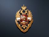 an image of a gold and red badge on a black wall