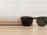 a pair of sunglasses sitting on top of a table next to a bag