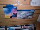 many boxes of brother products on display in a store