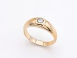a yellow gold ring with a diamond set in the center