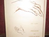 a white book with a drawing of a hand and a cat on it