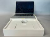 a laptop computer sitting in a white box on a table