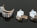 many different types of rings on a black surface