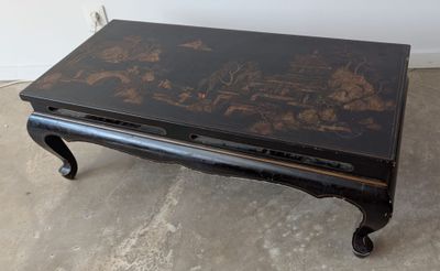 une table basse noire ornée d'un motif floral