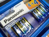 two piles of batteries sitting on top of each other on a table
